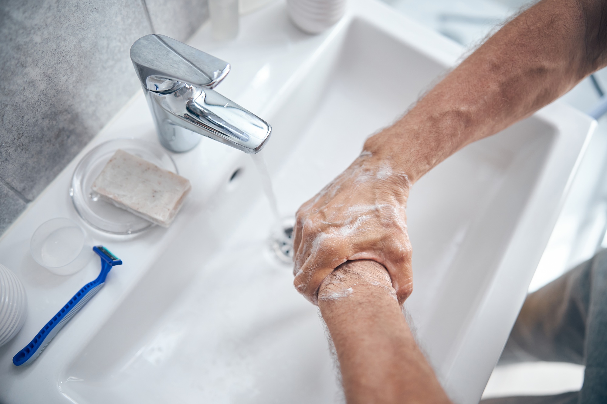 Adult Caucasian man performing a handwashing procedure
