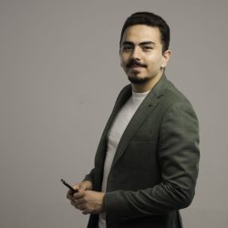 A businessman in dress code wearing grey jacket and posing. High quality photo