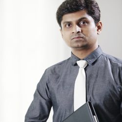 Portrait of serious Indian lawyer with leather folder